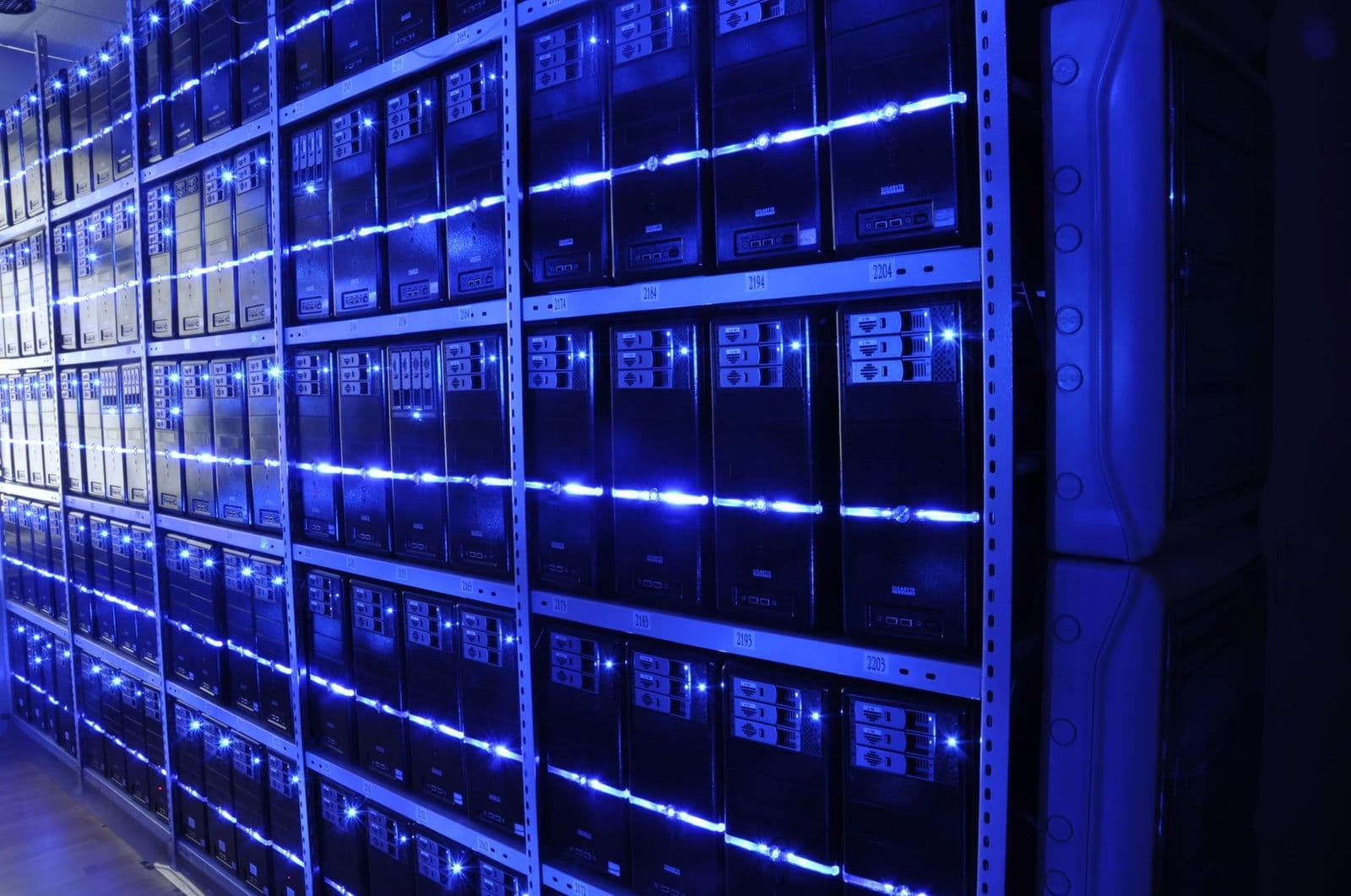 Rows of illuminated server racks inside a data centre.