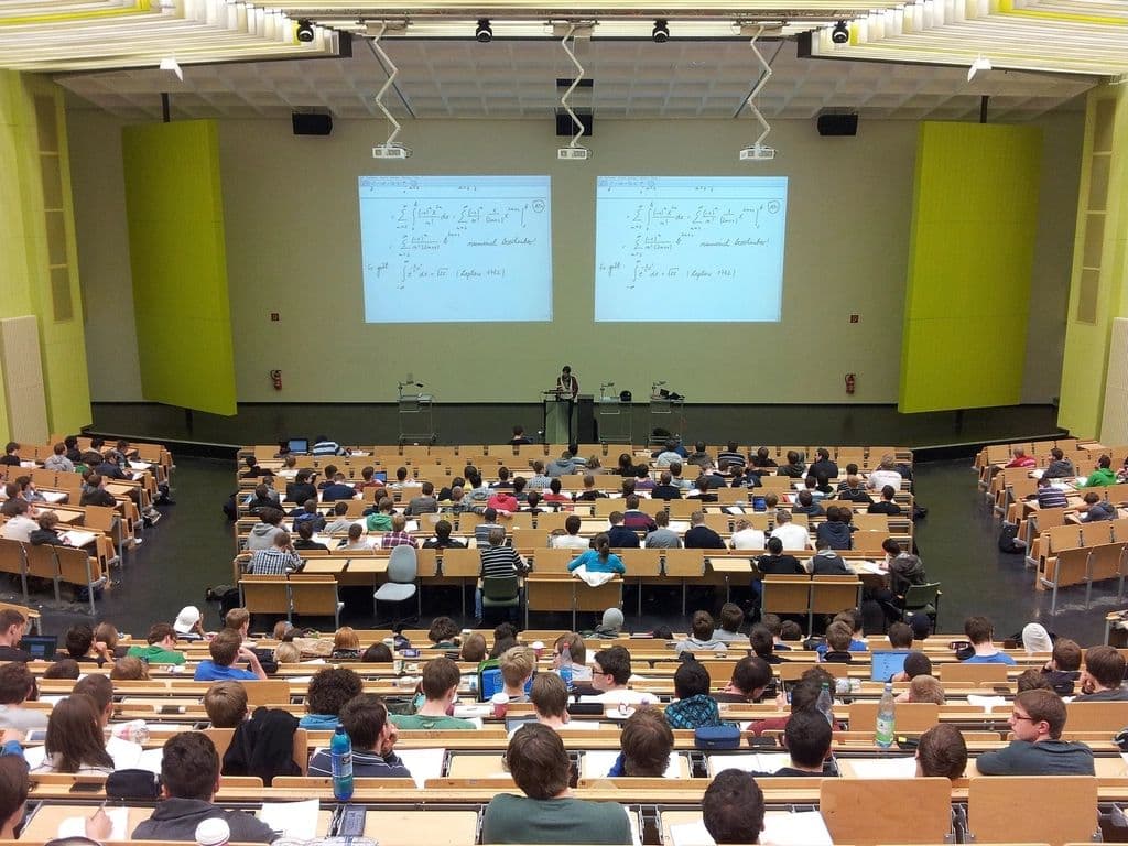 Students seated through a full university lecture hall.